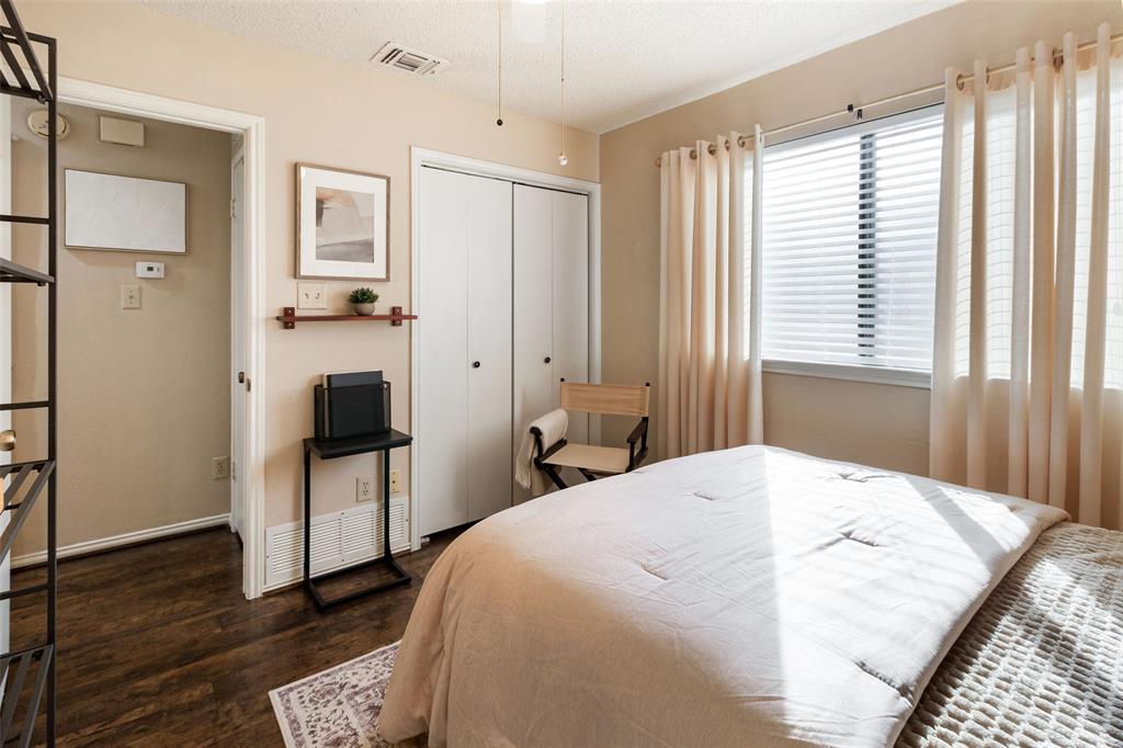 17490 Meandering Way, Unit 804 Dallas, TX 75252 - Photo 16 of 33 a spacious bedroom with a bed and a television