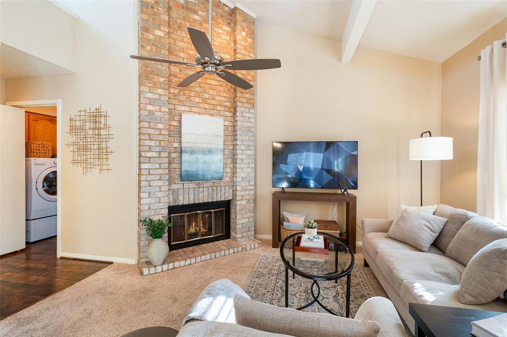 17490 Meandering Way, Unit 804 Dallas, TX 75252 - Photo 19 of 33 a living room with furniture a fireplace and a floor to ceiling window