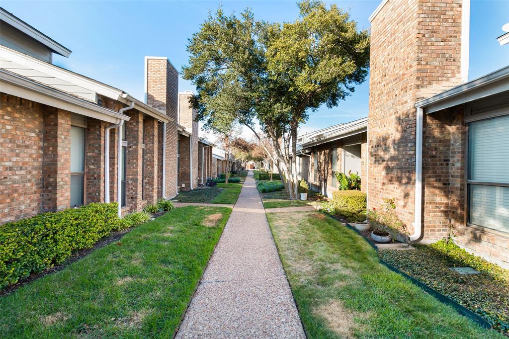 17490 Meandering Way, Unit 804 Dallas, TX 75252 - Photo 26 of 33 a view of a brick house with a big yard plants and large trees