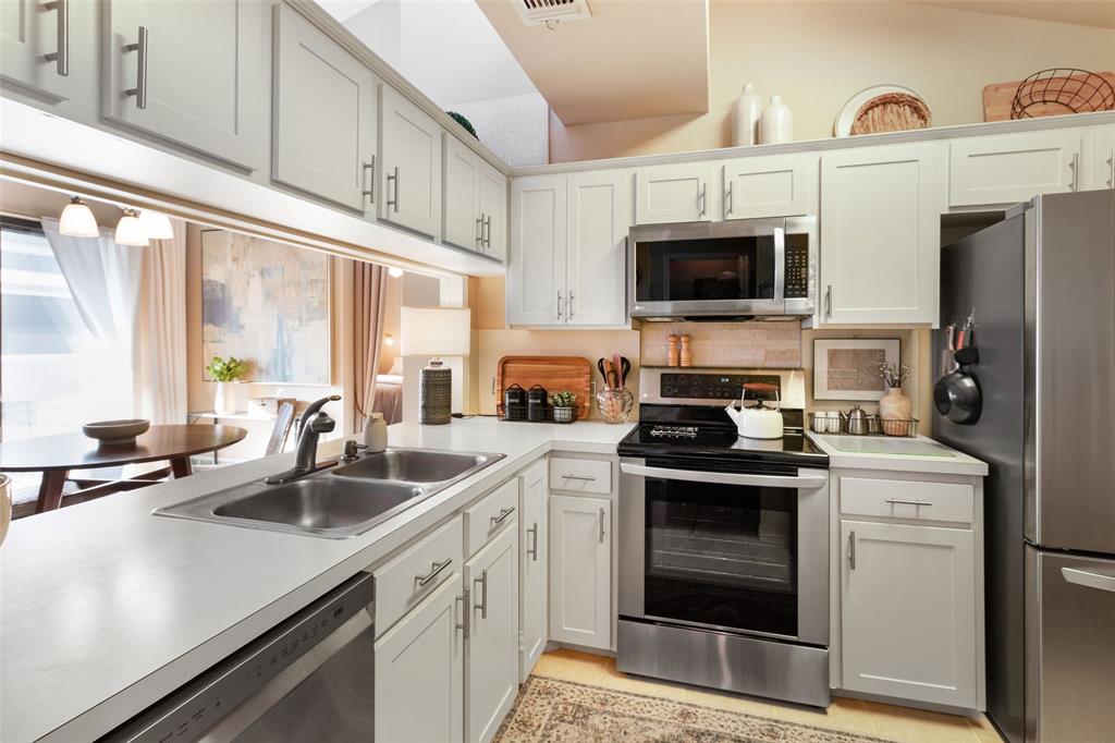 17490 Meandering Way, Unit 804 Dallas, TX 75252 - Photo 4 of 33 a kitchen with a sink stove top oven and refrigerator