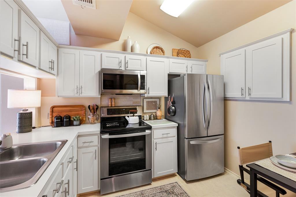 17490 Meandering Way, Unit 804 Dallas, TX 75252 - Photo 5 of 33 a kitchen with stainless steel appliances a refrigerator stove microwave and sink