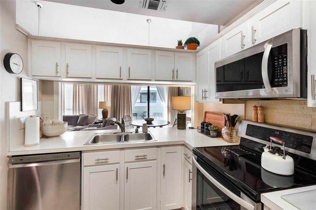17490 Meandering Way, Unit 804 Dallas, TX 75252 - Photo 6 of 33 a kitchen with stainless steel appliances granite countertop a sink and cabinets