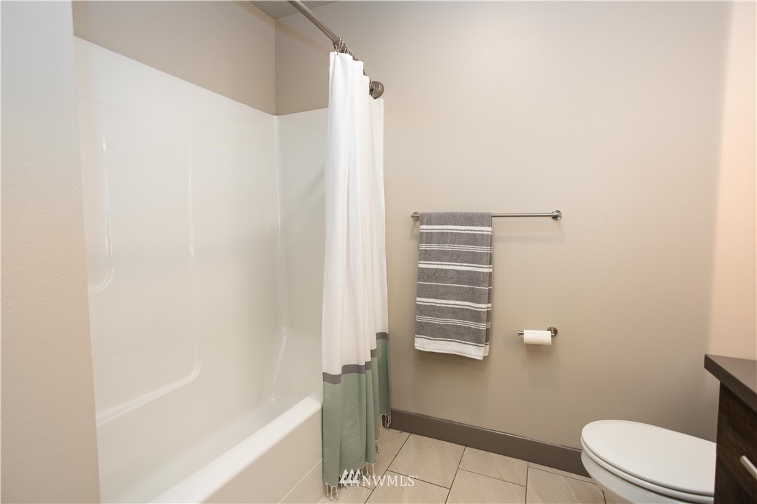 1880 Front Street, Unit 206 Lynden, WA 98264 - Photo 19 of 30 a bathroom with a shower and a toilet