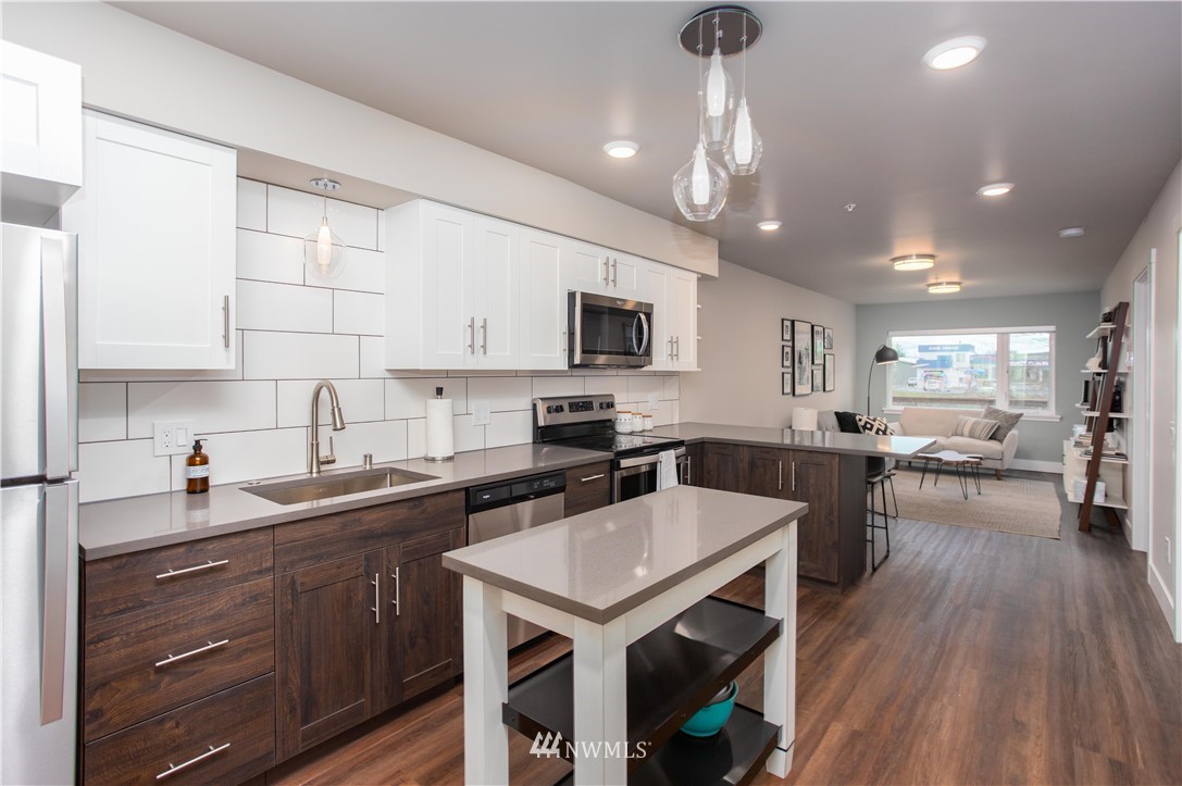 1880 Front Street, Unit 206 Lynden, WA 98264 - Photo 8 of 30 a kitchen with a center island appliances and cabinets