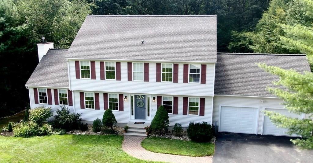 a aerial view of a house with a yard and potted plants