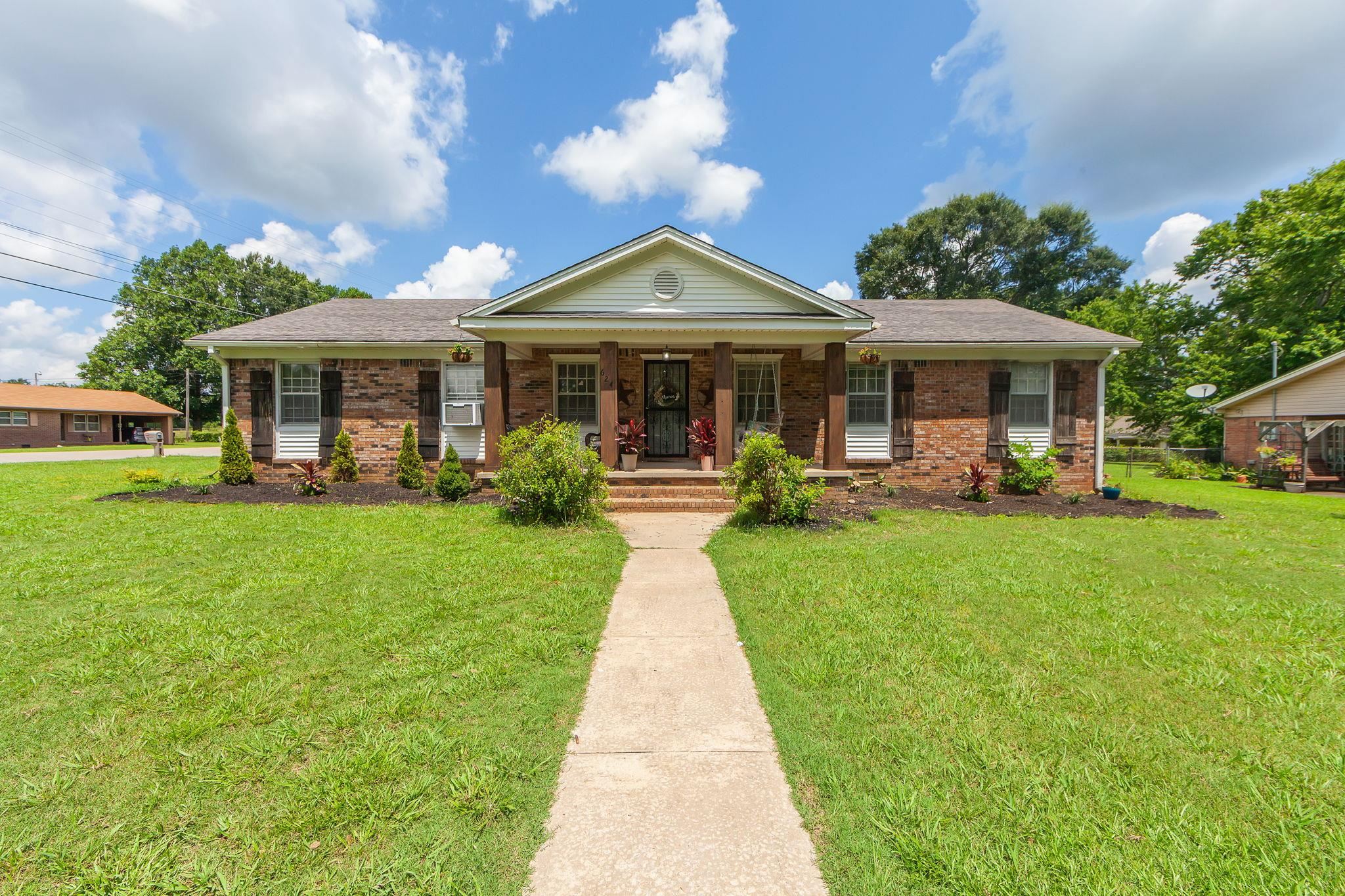 624 Ridgeway Drive Bolivar, TN 38008 - Photo 1 of 19 a front view of a house with a yard table and chairs