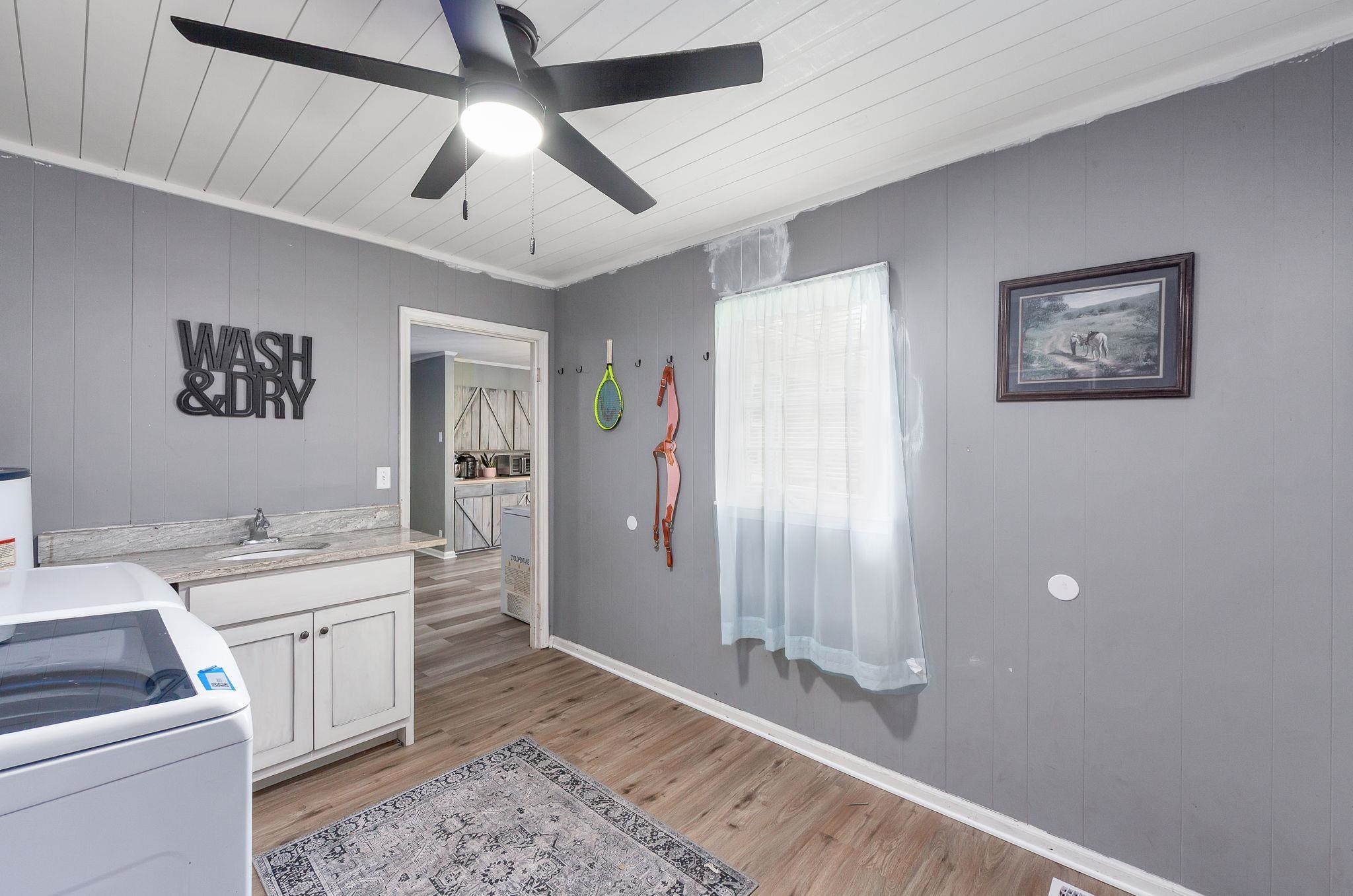 624 Ridgeway Drive Bolivar, TN 38008 - Photo 19 of 19 a room with a white bed and a chandelier