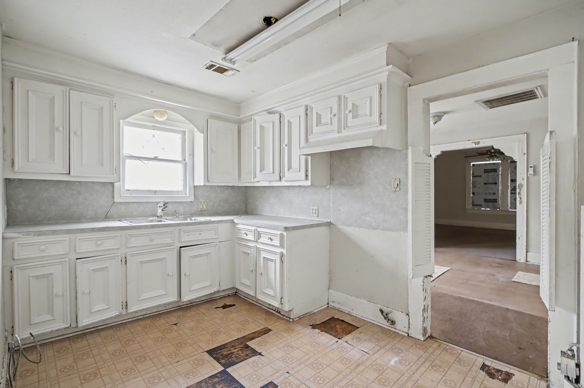 1218 Genova Street Houston, TX 77009 - Photo 12 of 15 a kitchen with white cabinets and sink