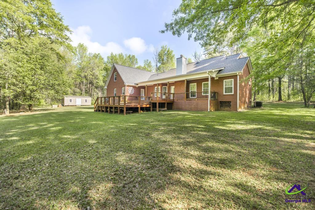 204 Smith Road Haddock, GA 31033 - Photo 40 of 51 a view of a house with a big yard and large trees