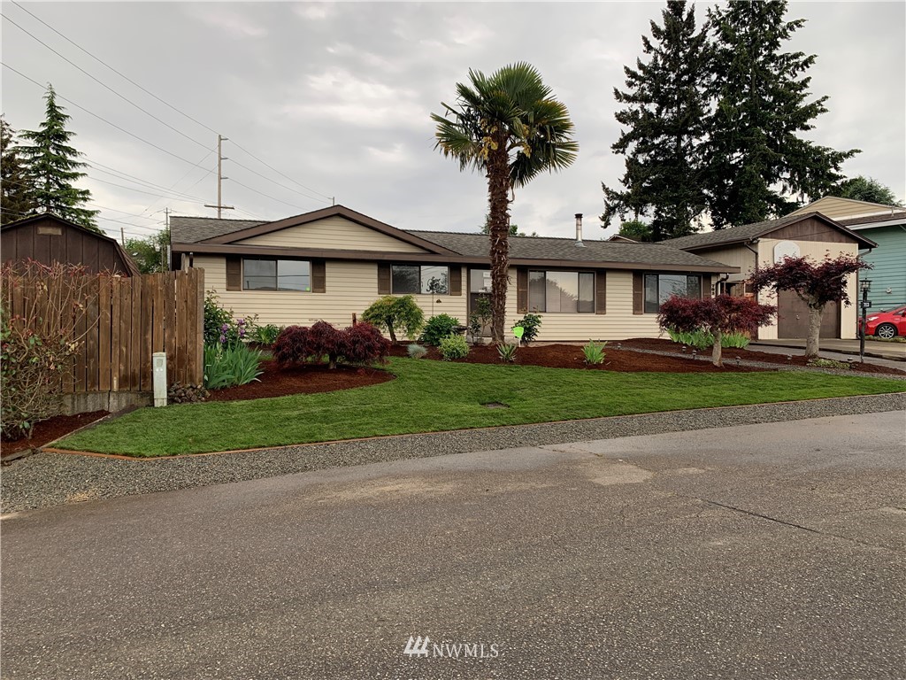 703 South 17th Street Renton, WA 98055 - Photo 1 of 20 a front view of a house with a garden and plants