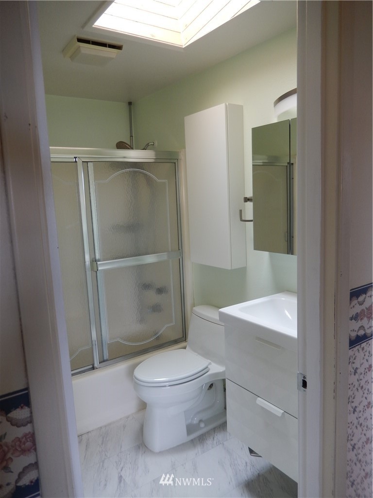 703 South 17th Street Renton, WA 98055 - Photo 13 of 20 a white toilet sitting next to a bathroom sink