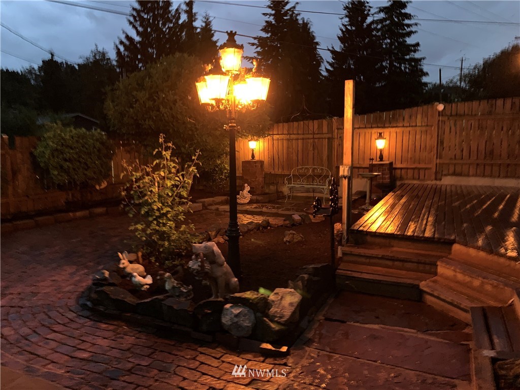 703 South 17th Street Renton, WA 98055 - Photo 3 of 20 a view of a patio with dining table and chairs