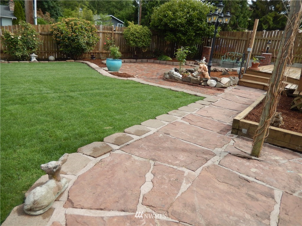 703 South 17th Street Renton, WA 98055 - Photo 4 of 20 a view of a backyard with sitting area and slide