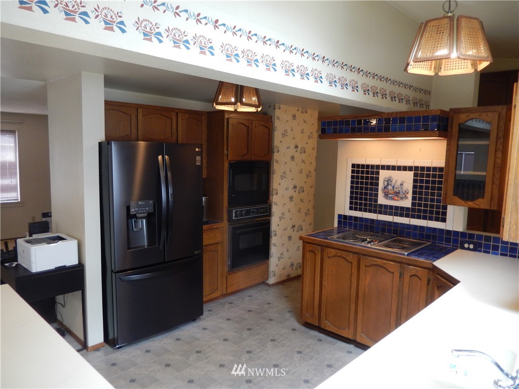 703 South 17th Street Renton, WA 98055 - Photo 7 of 20 a kitchen with stainless steel appliances granite countertop a refrigerator and a sink