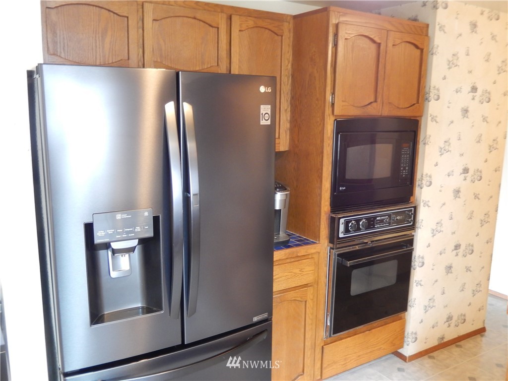 703 South 17th Street Renton, WA 98055 - Photo 10 of 20 a kitchen with stainless steel appliances granite countertop a refrigerator and a stove