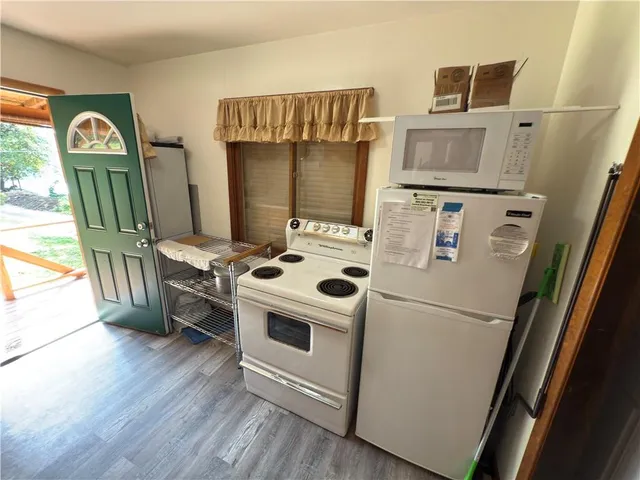 a white refrigerator freezer and a stove sitting inside of a kitchen