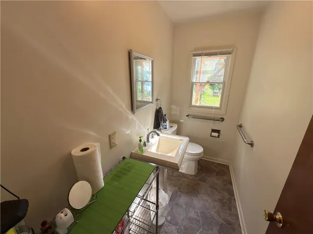 a bathroom with a toilet sink and mirror