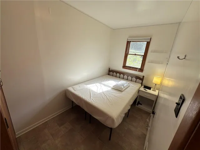 a bedroom with a bed and a mirror