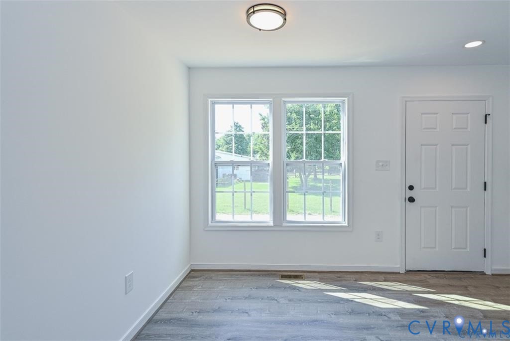993 Swan Lane Ruther Glen, VA 22546 - Photo 12 of 31 an empty room with wooden floor and windows