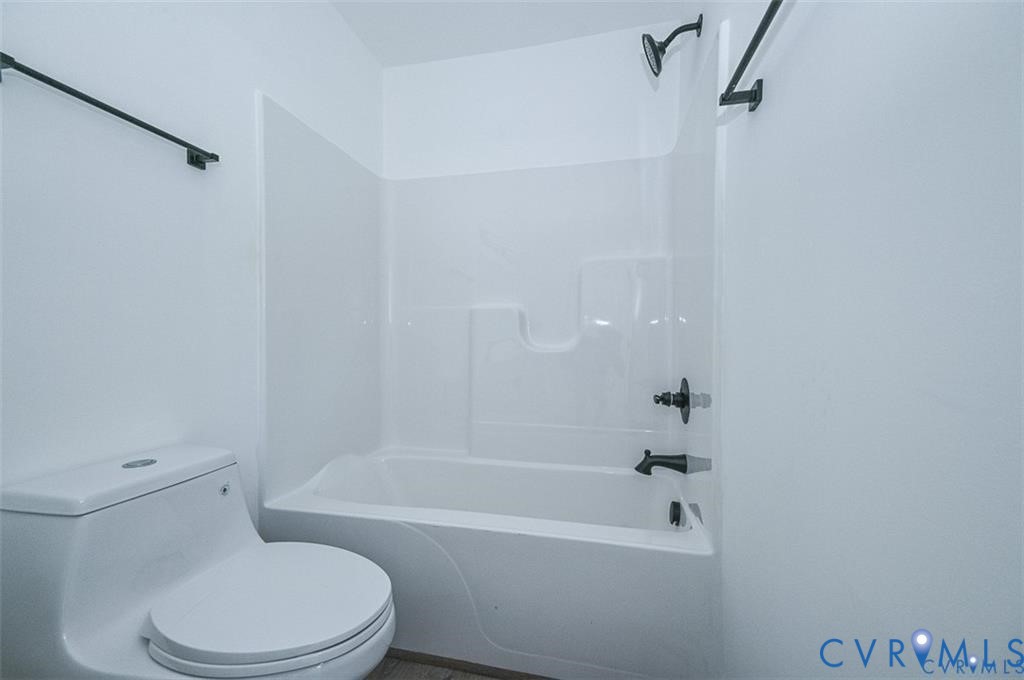 993 Swan Lane Ruther Glen, VA 22546 - Photo 24 of 31 a white toilet and tub sitting next to a bathroom sink