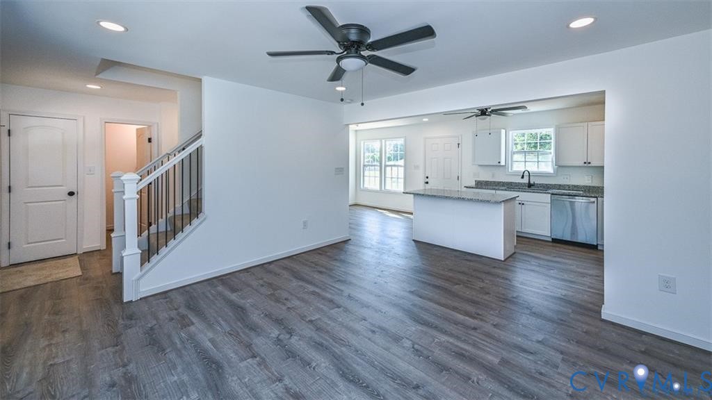 993 Swan Lane Ruther Glen, VA 22546 - Photo 6 of 31 a kitchen with granite countertop a stove and a wooden floors