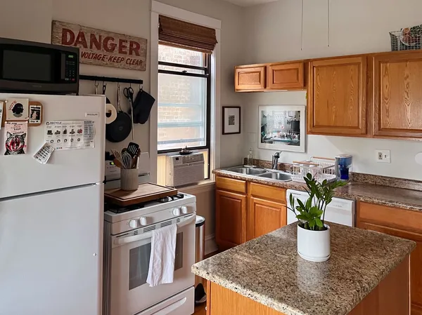 a kitchen with a refrigerator and a sink