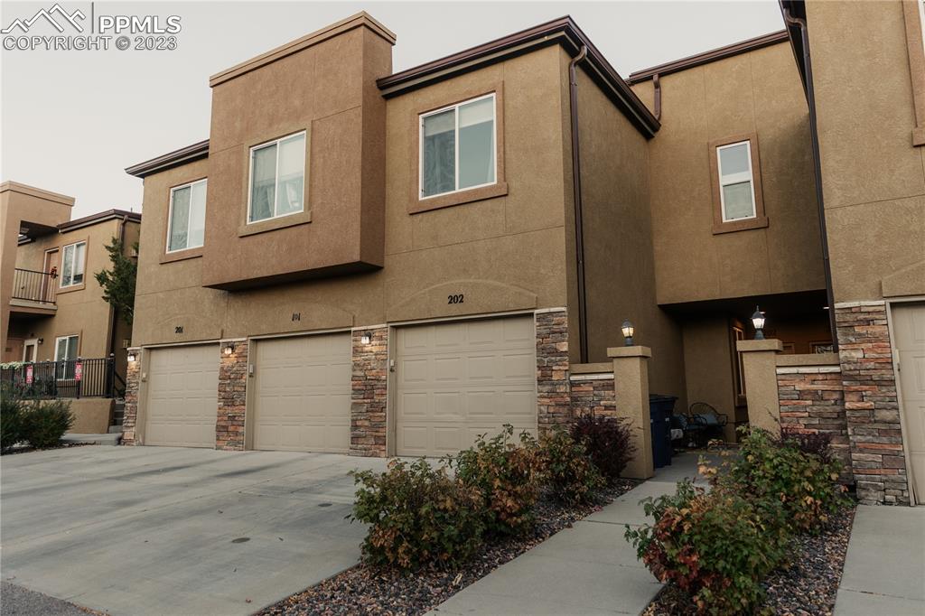4848 Kerry Lynn View, Unit 202 Colorado Springs, CO 80922 - Photo 1 of 14 a view of a house with a street