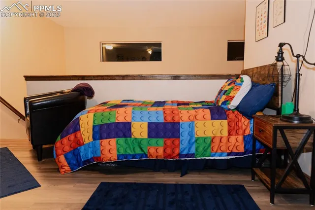 a living room with blue wall paintings and a couch