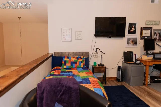a bed room with furniture and a flat screen tv