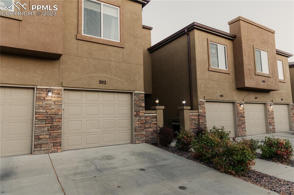 4848 Kerry Lynn View, Unit 202 Colorado Springs, CO 80922 - Photo 2 of 14 a front view of a house with garage