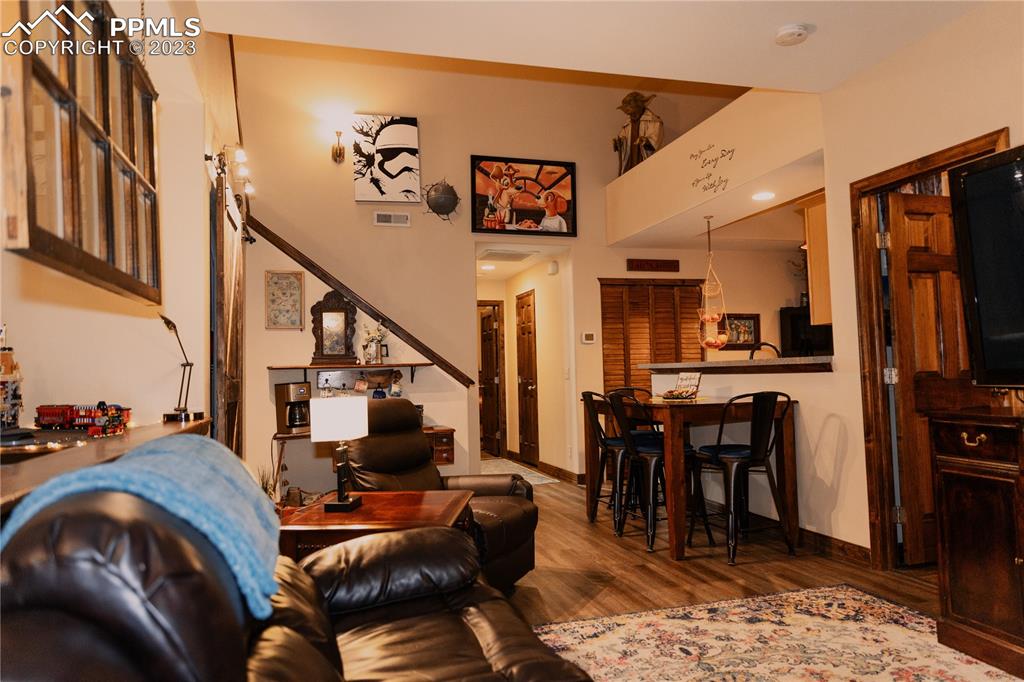 4848 Kerry Lynn View, Unit 202 Colorado Springs, CO 80922 - Photo 3 of 14 a view of a livingroom with furniture a rug wooden floor and a chandelier