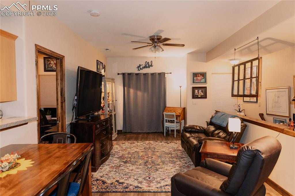 4848 Kerry Lynn View, Unit 202 Colorado Springs, CO 80922 - Photo 4 of 14 a living room with furniture a flat screen tv and a table