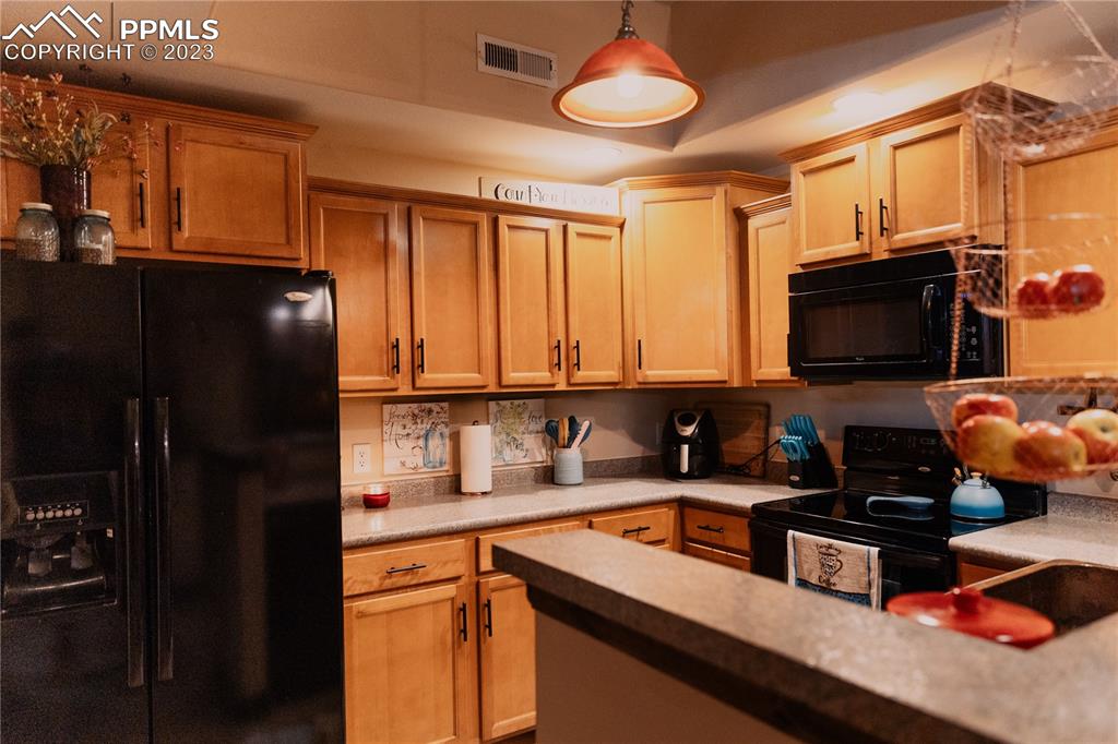 4848 Kerry Lynn View, Unit 202 Colorado Springs, CO 80922 - Photo 6 of 14 a kitchen with a sink a stove and a microwave