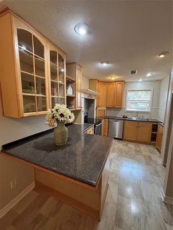 a kitchen with a refrigerator and cabinets