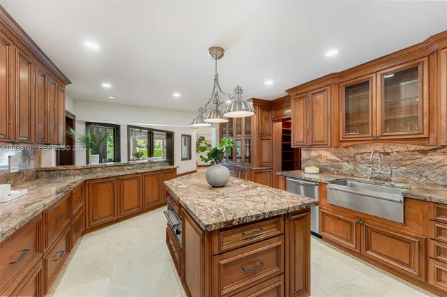 a living room with furniture a chandelier and a fireplace