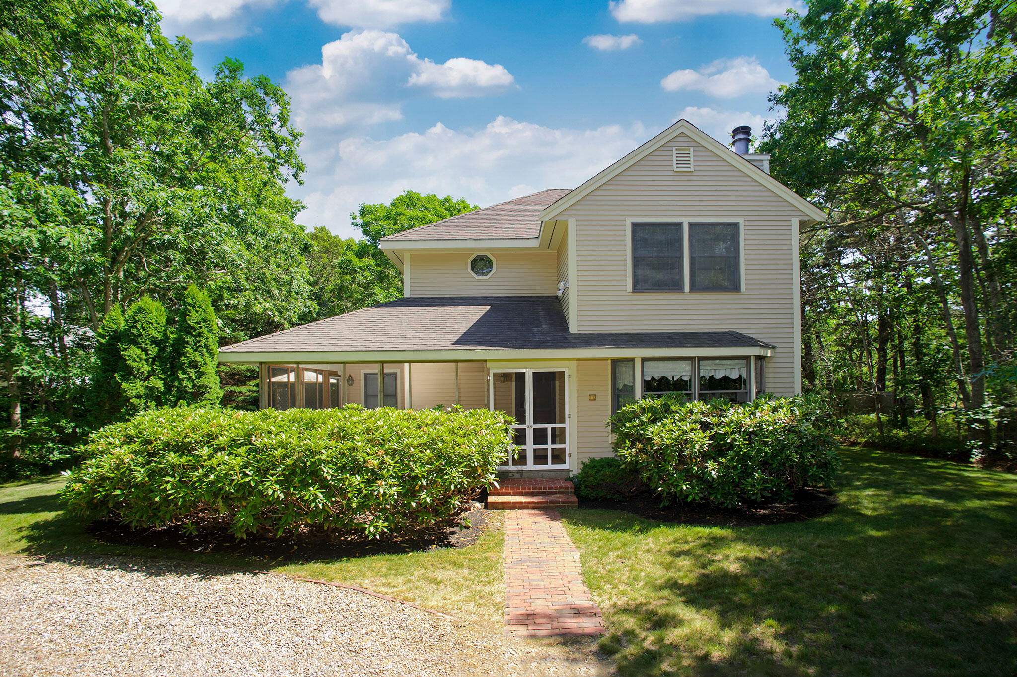 a front view of a house with a garden