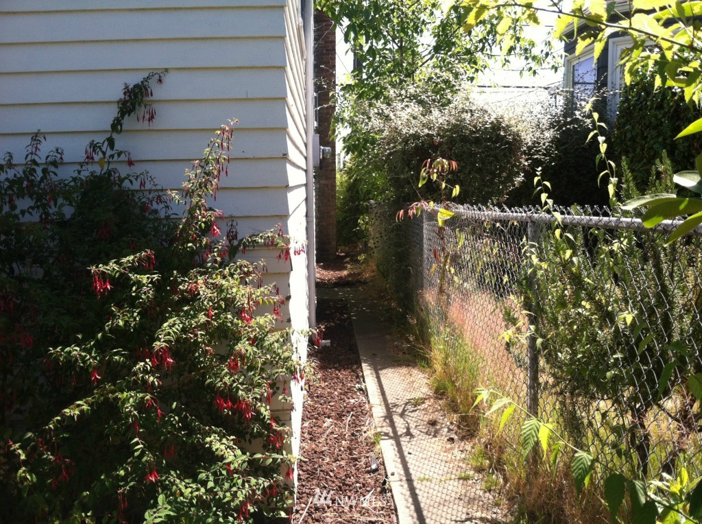 816 North 46th Street Seattle, WA 98103 - Photo 8 of 21 a view of a house with a yard and flower garden