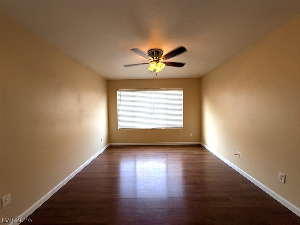 4955 South Lindell Road, Unit 203 Las Vegas, NV 89118 - Photo 17 of 31 Hardwood floors and a window with blinds define this versatile room.