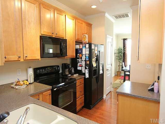 106 Cedar Elm Road Durham, NC 27713 - Photo 12 of 23 a kitchen with stainless steel appliances granite countertop a stove a sink and a microwave