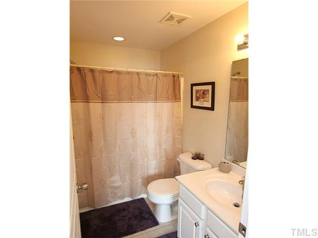 106 Cedar Elm Road Durham, NC 27713 - Photo 13 of 23 a bathroom with a sink a toilet and shower