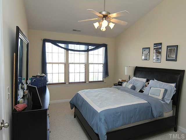 106 Cedar Elm Road Durham, NC 27713 - Photo 15 of 23 a bedroom with a bed and a chandelier