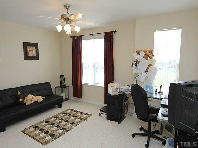 106 Cedar Elm Road Durham, NC 27713 - Photo 18 of 23 a bedroom with furniture and a window