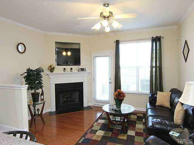 106 Cedar Elm Road Durham, NC 27713 - Photo 4 of 23 a living room with furniture a fireplace and a flat screen tv