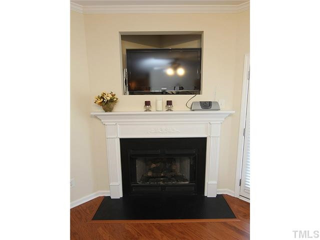 106 Cedar Elm Road Durham, NC 27713 - Photo 6 of 23 a living room with a fireplace and a flat screen tv