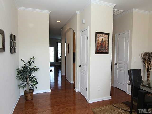 106 Cedar Elm Road Durham, NC 27713 - Photo 10 of 23 a view of a hallway with wooden floor and a potted plant