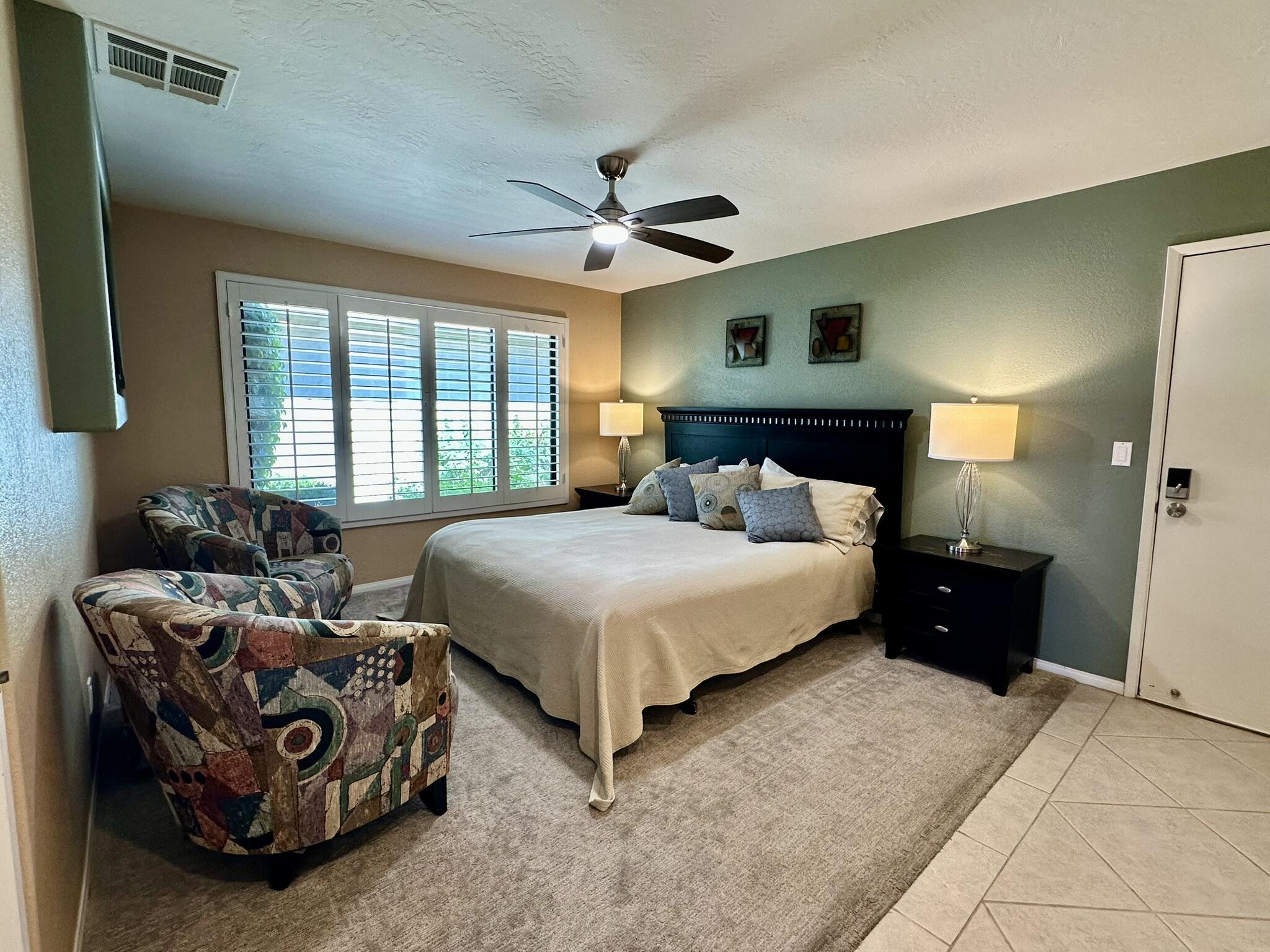 264 Ave Del Sol Palm Desert, CA 92260 - Photo 12 of 15 a bedroom with a bed and a chandelier