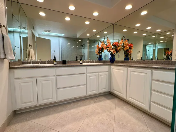 a bathroom with a toilet a sink and glass door shower
