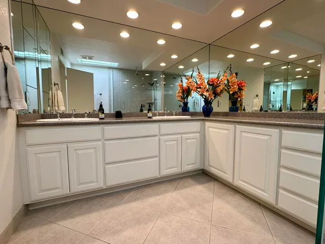 a bathroom with a toilet a sink and glass door shower