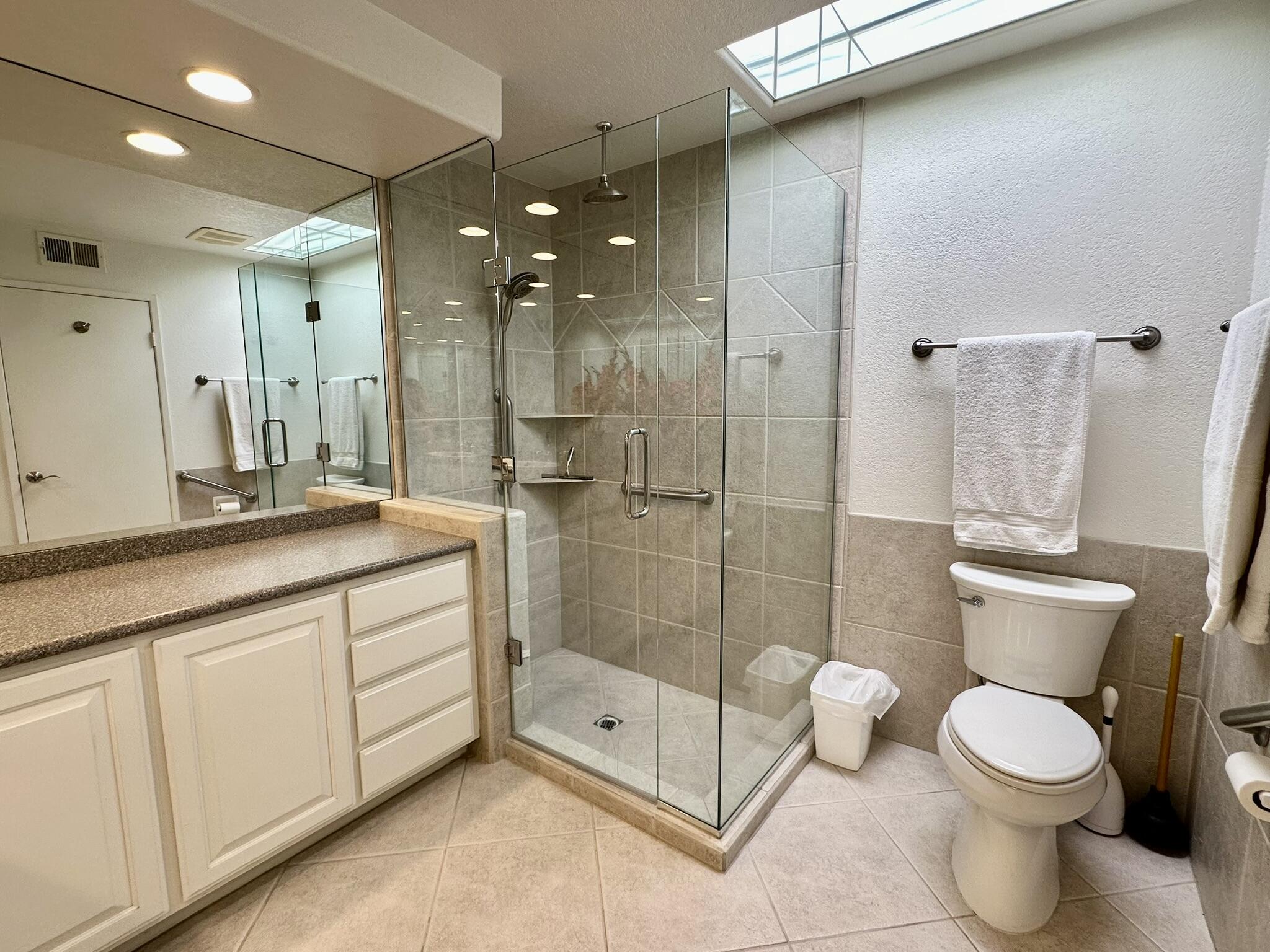 264 Ave Del Sol Palm Desert, CA 92260 - Photo 14 of 15 a bathroom with a toilet a sink and glass door shower