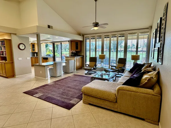 a living room with furniture and large windows